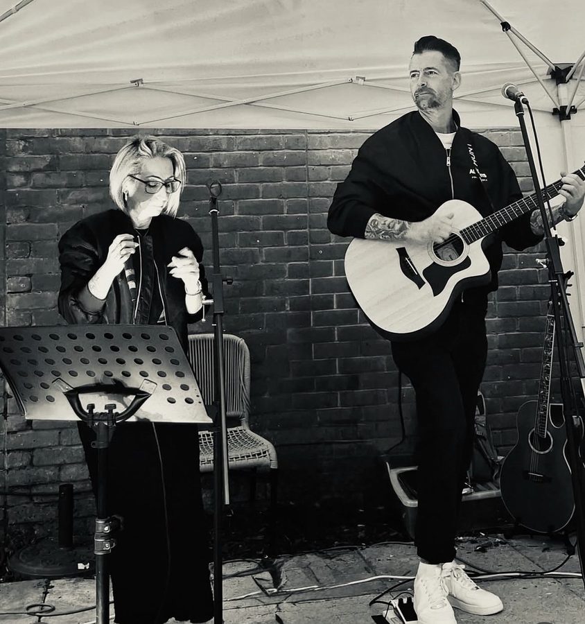 Vix and DS playing an outdoor gig under a gazebo